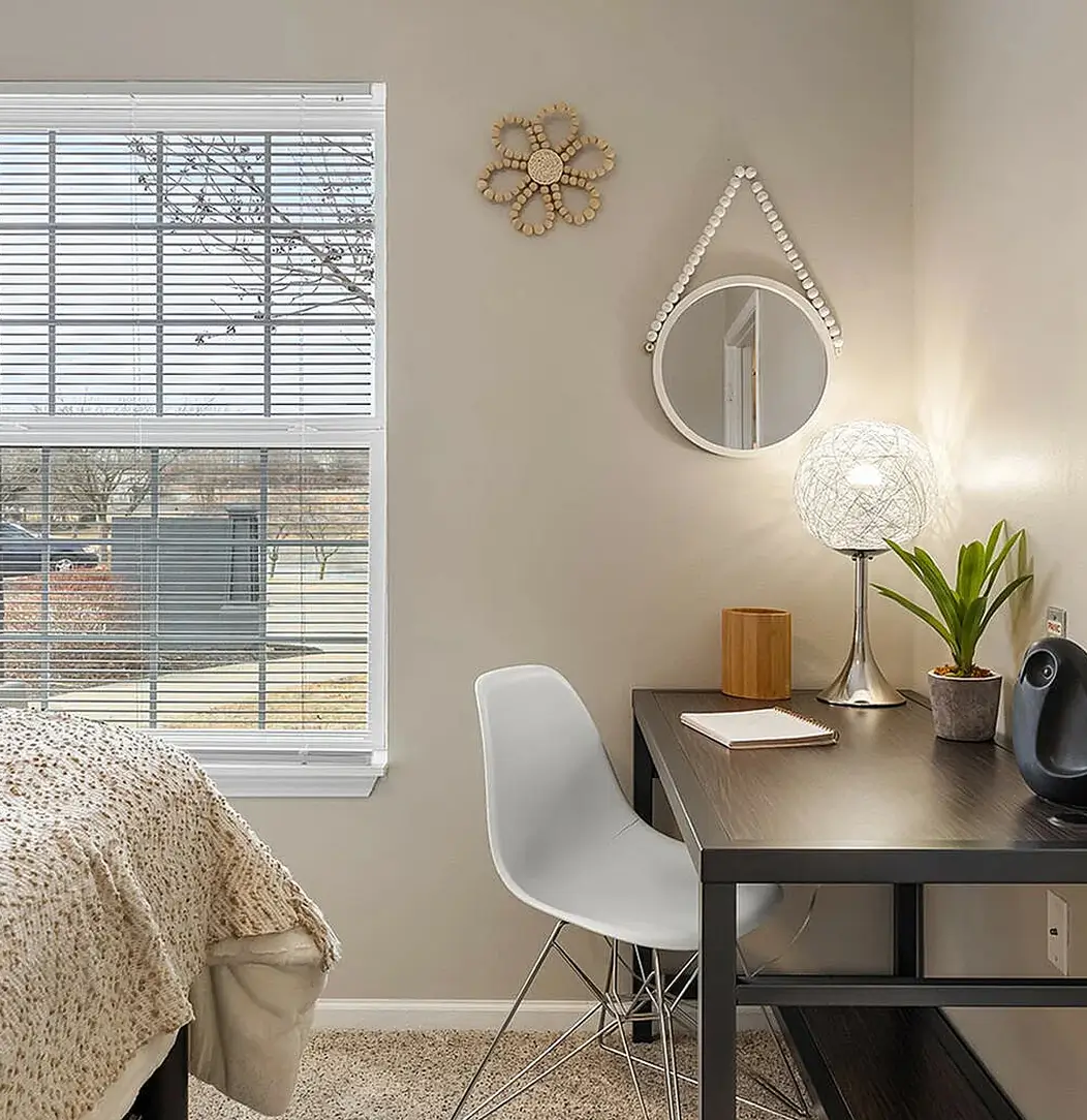 Apartment bedroom featuring a desk and chair
