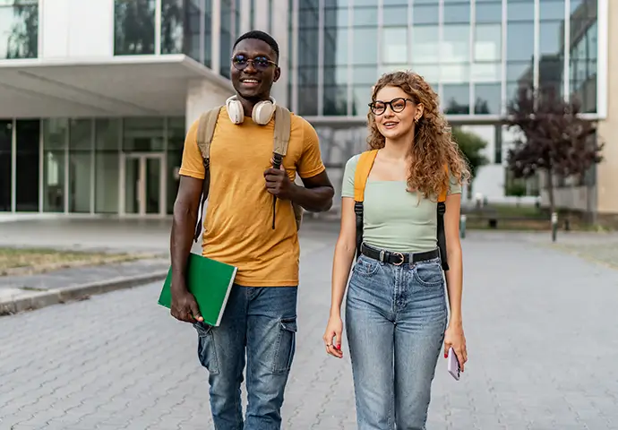two young college students walking to class